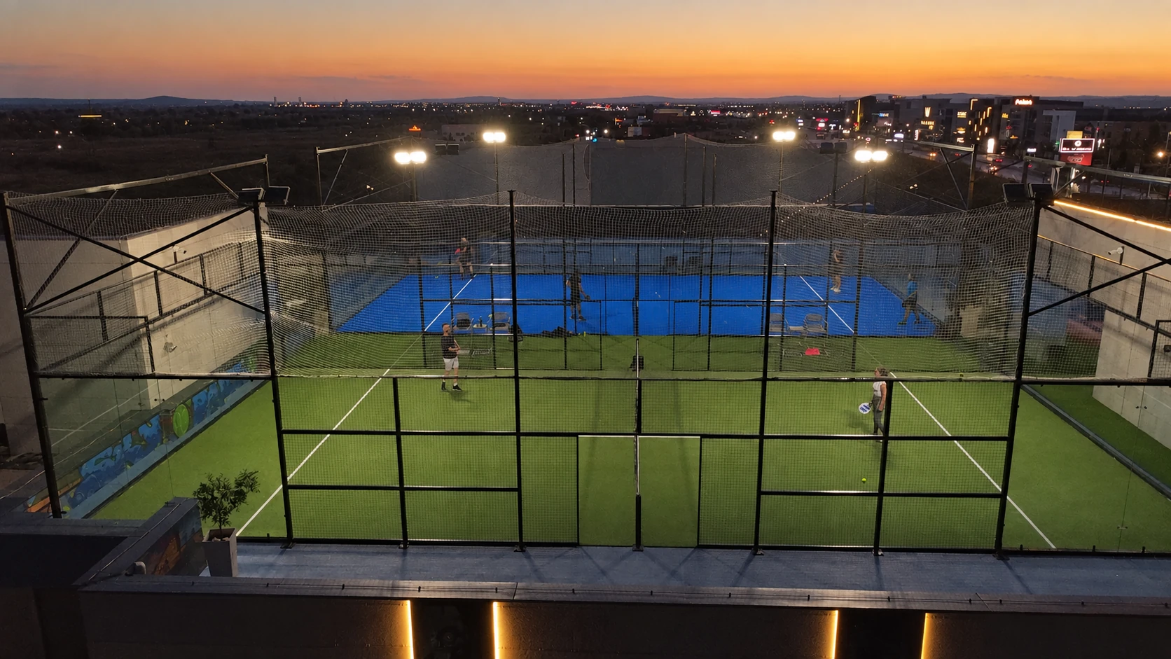 Golden-hour lighting edit of the current Sky Padel rooftop courts
