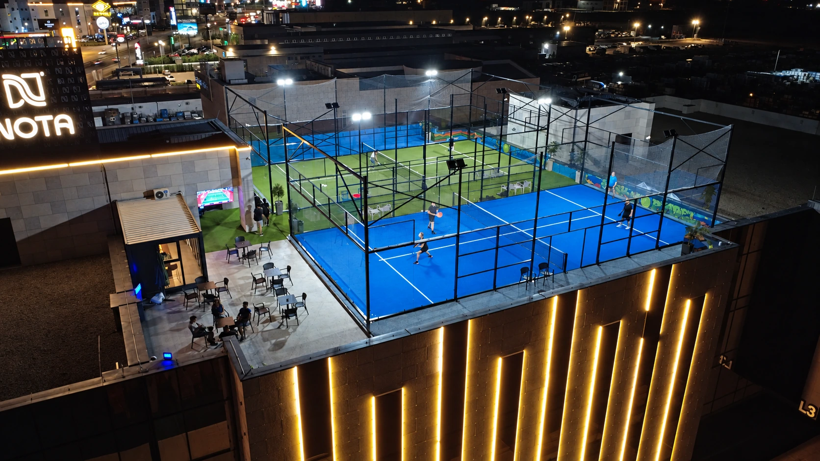 Players on the rooftop courts after dark