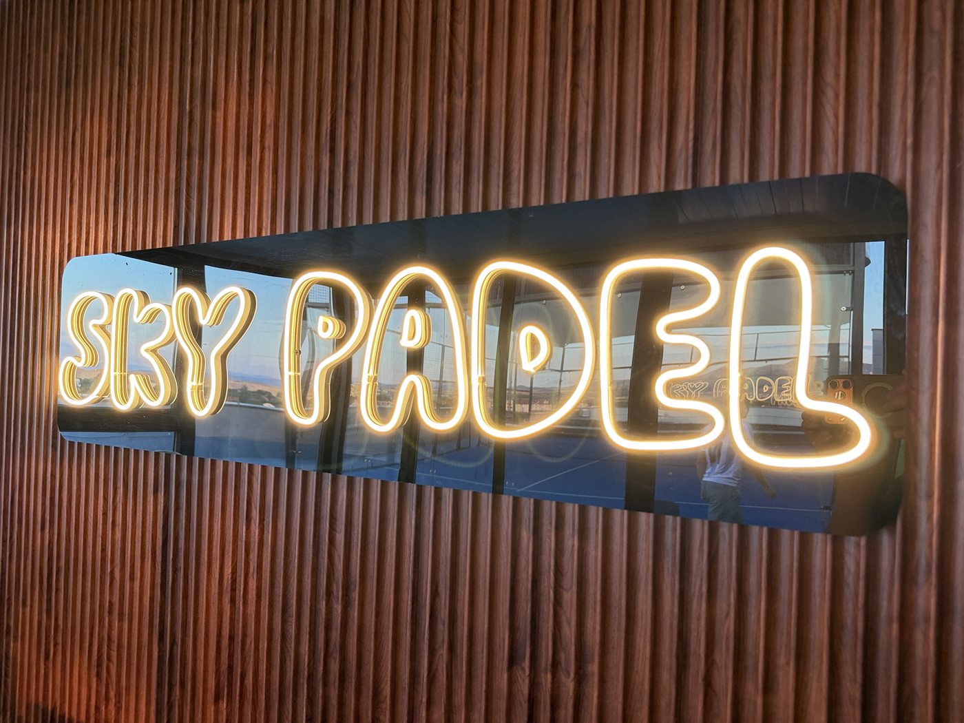 Illuminated Sky Padel sign on the fourth floor
