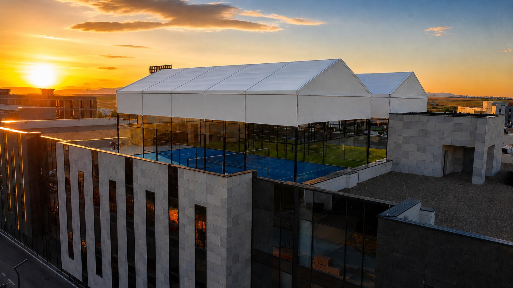 Sky Padel rooftop courts glowing in the Prishtina sunset